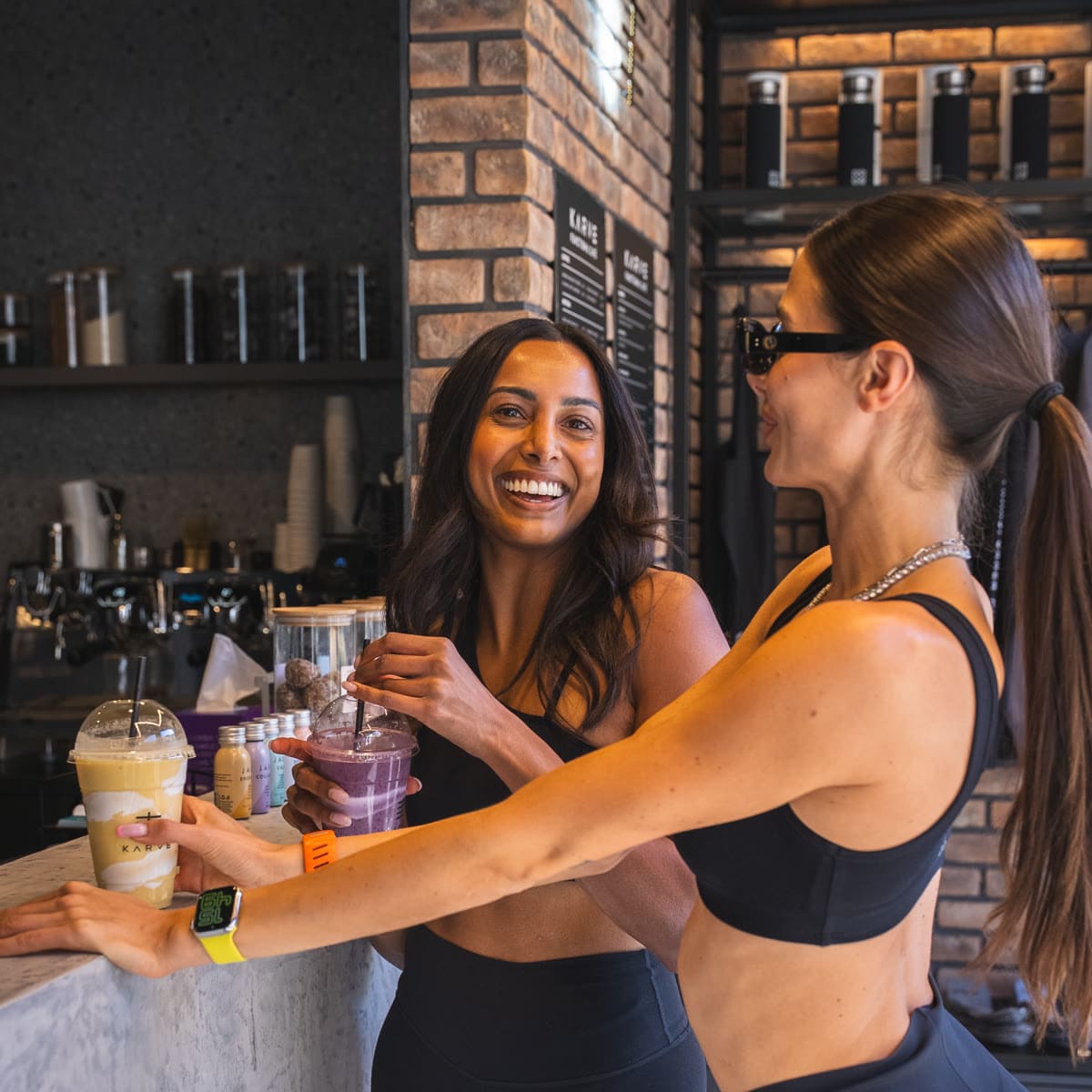 Guests laughing with their shakes at the KARVE Café counter Guests laughing with their shakes at the KARVE Café counter